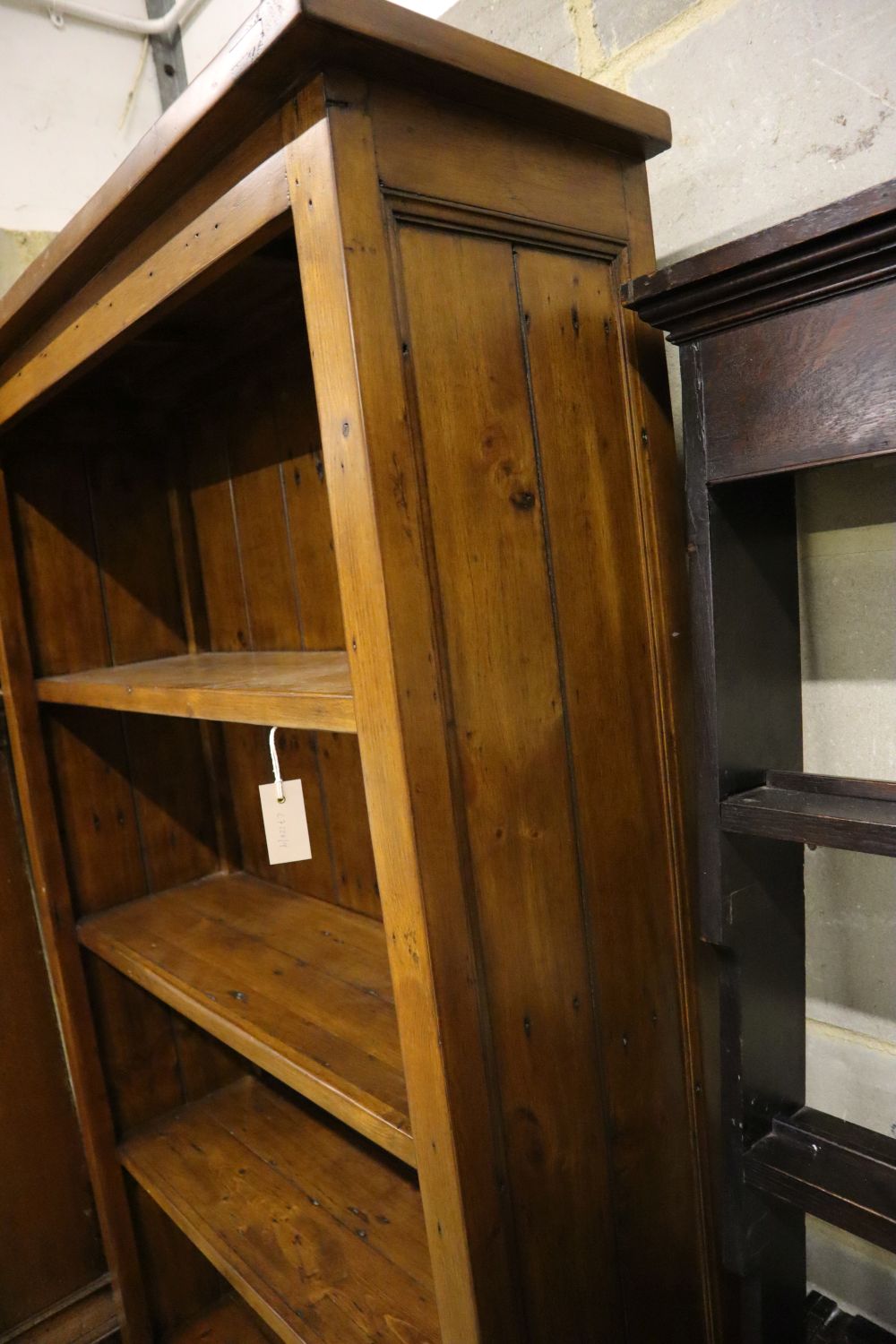 A modern stained pine open shelved bookcase, width 98cm depth 33cm height 198cm